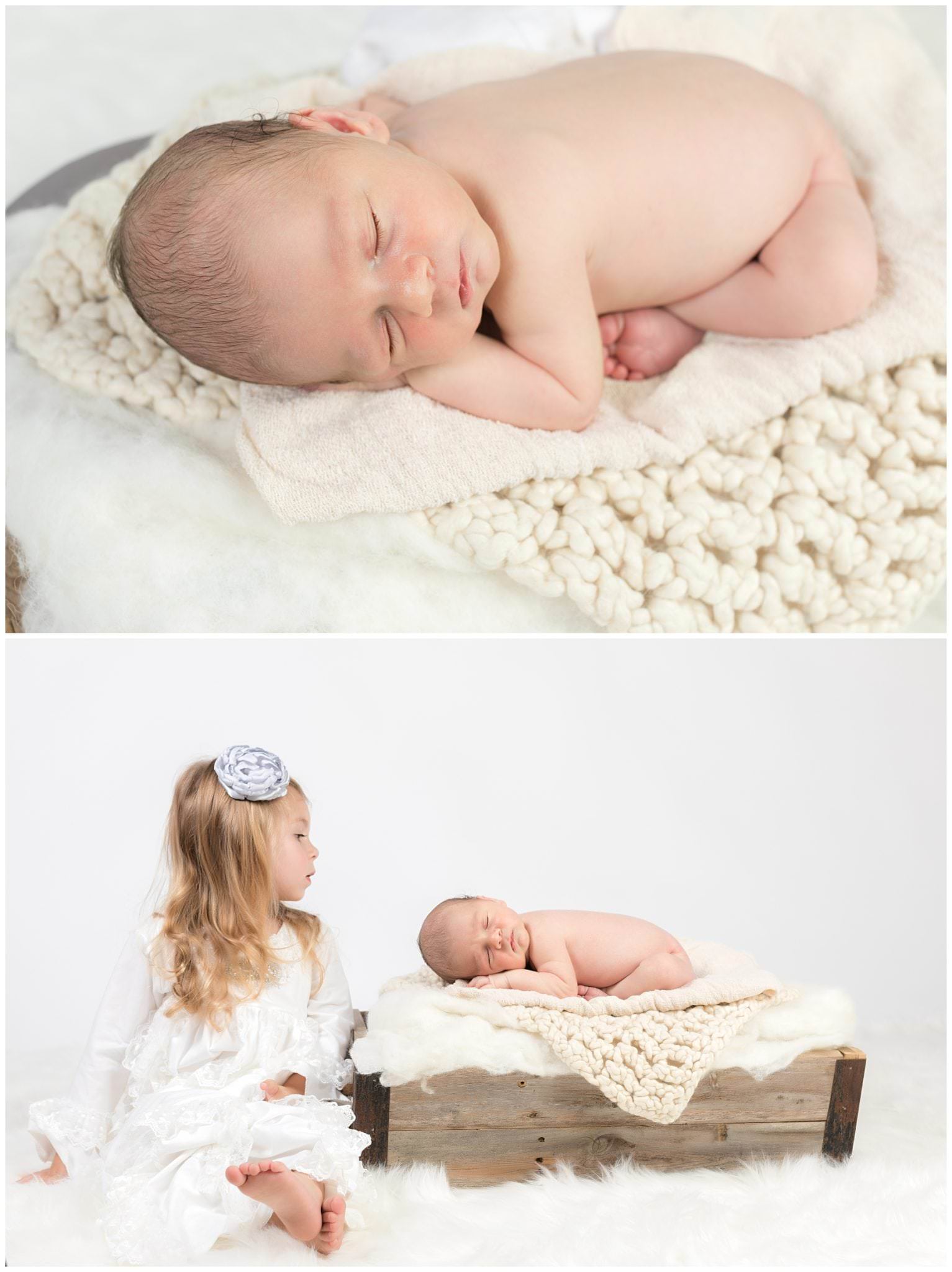 Newborn on white blankets with big sister