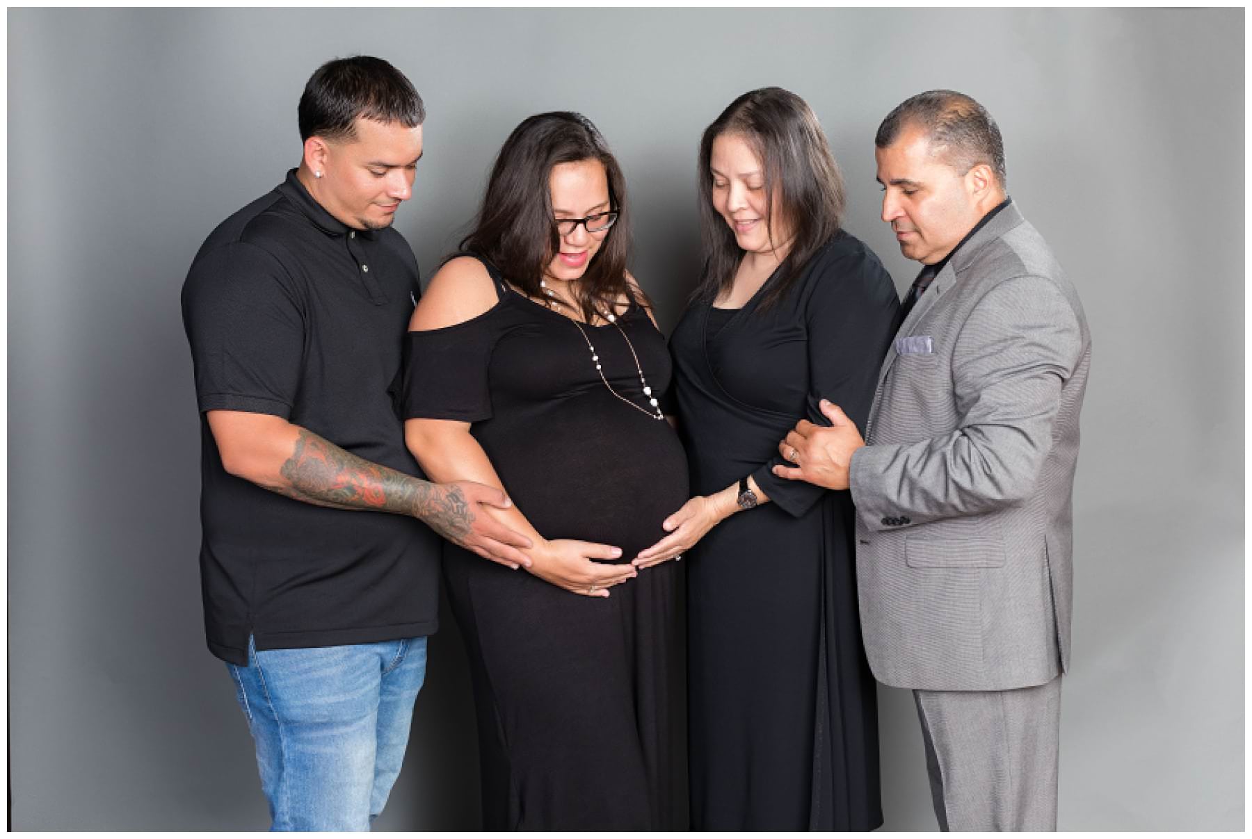 Maternity photos with family in studio on grey background