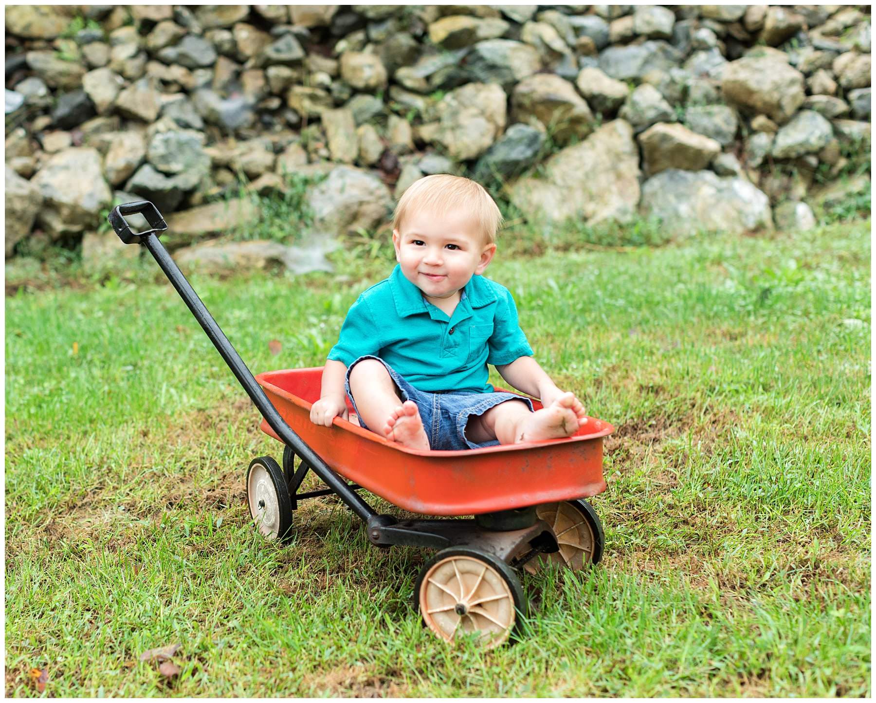Outdoor kids portraits in wagon with stone wall background