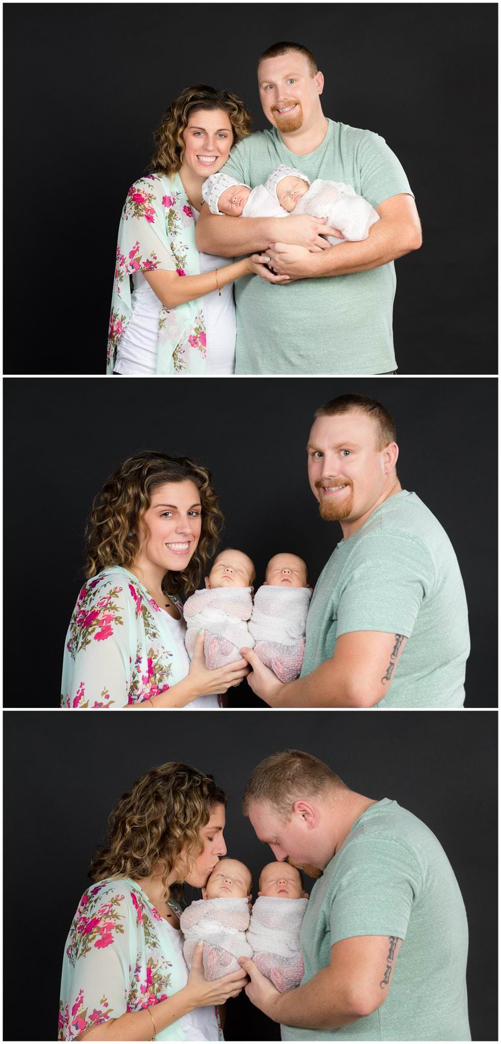 parents with newborn twins on black backdrop