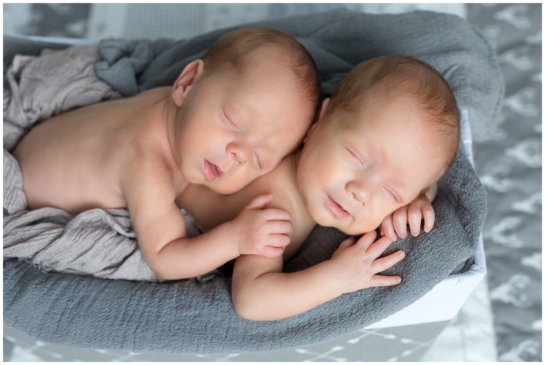 newborn twins smiling