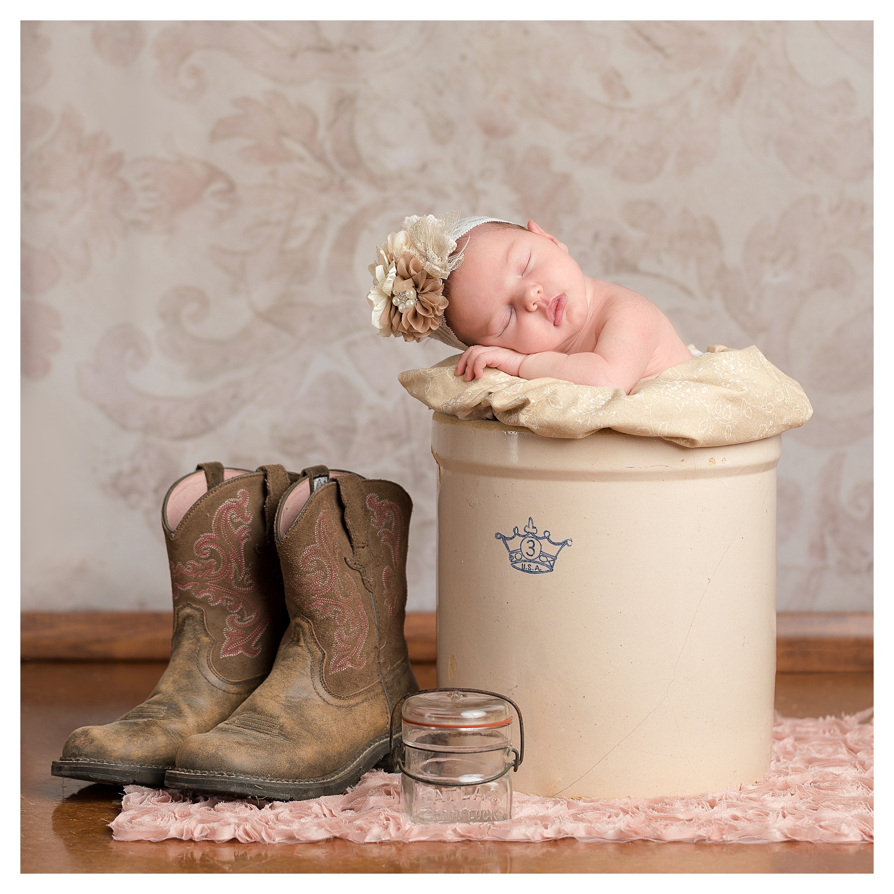 newborn in antique crock with cowboy boots