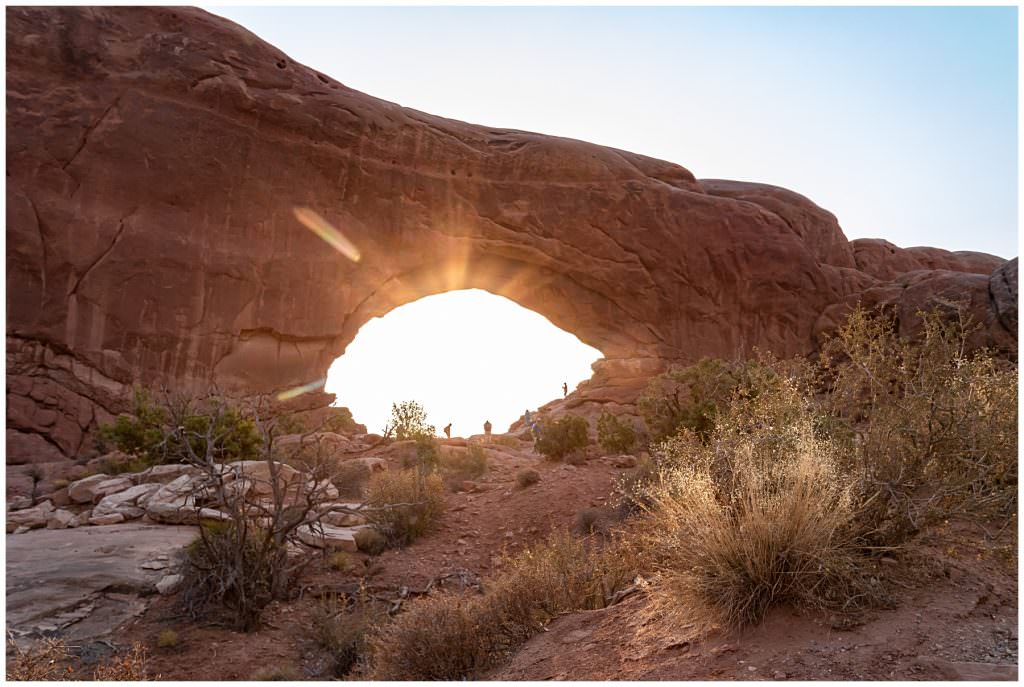 sunlight bursting through arch in utah national park