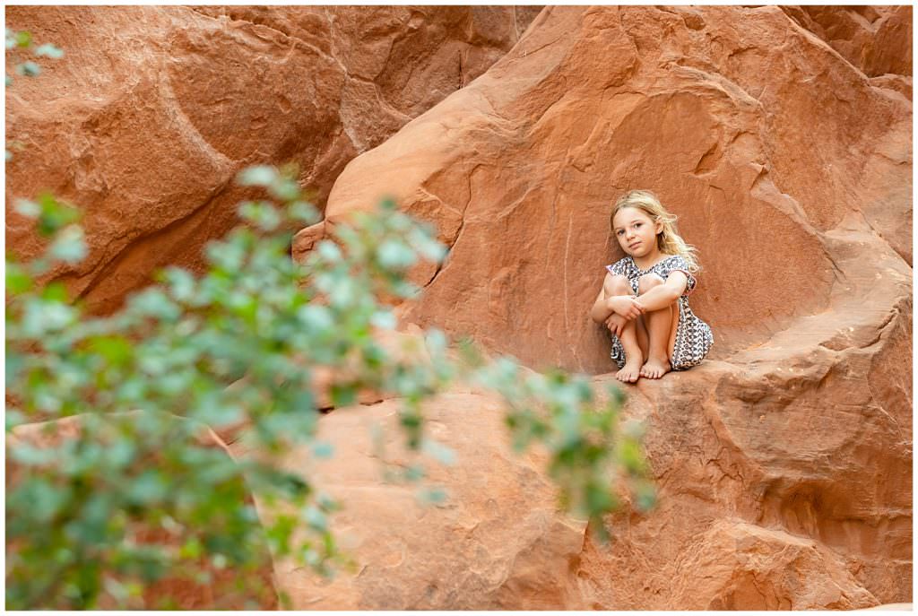 girl rock climbing at arches national park