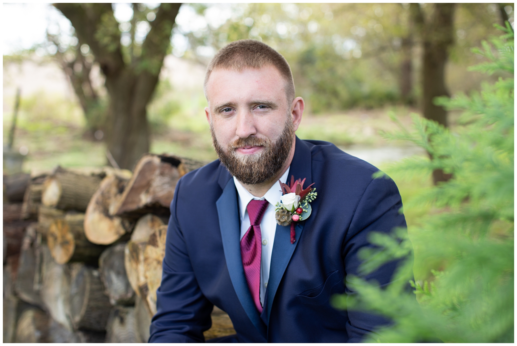groom portrait outdoors with logs