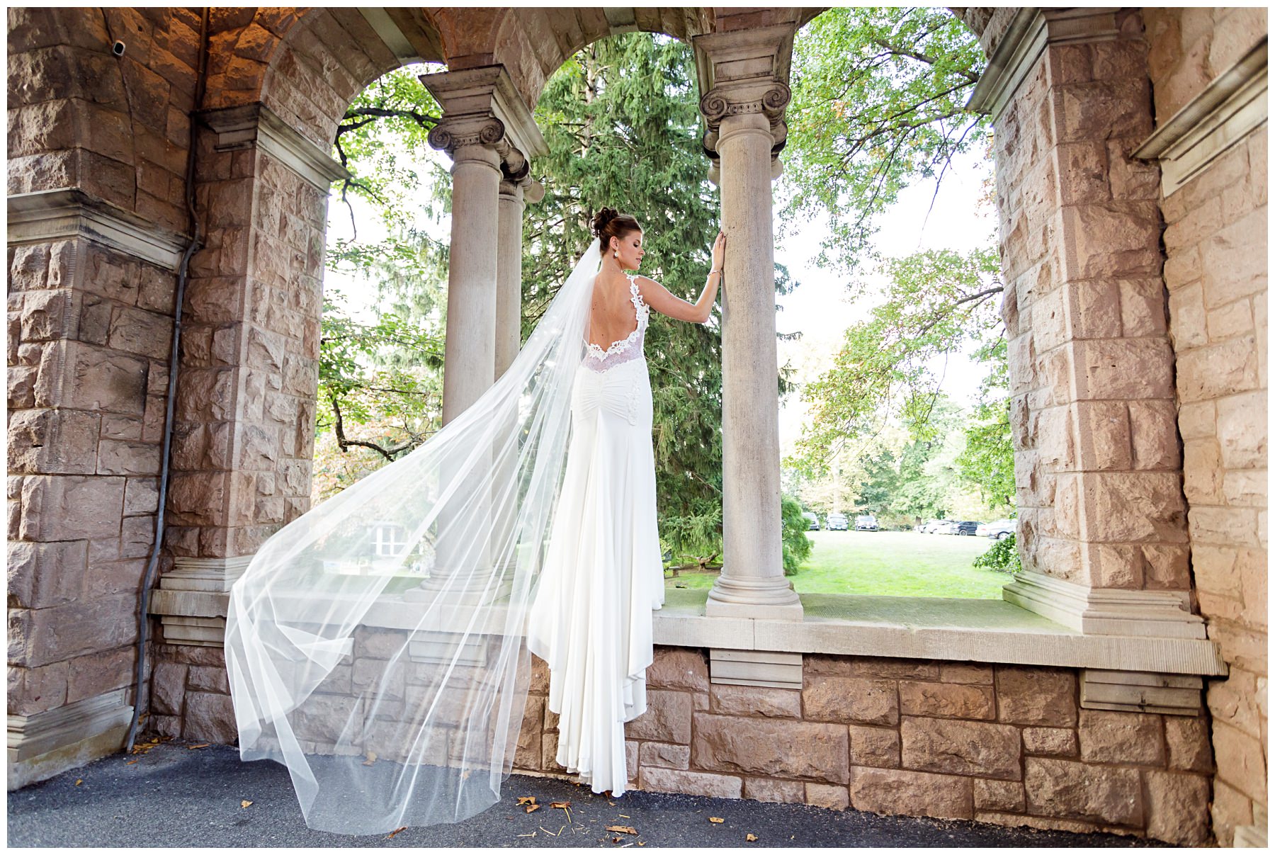 bridal portrait with flowing veil and historic archways